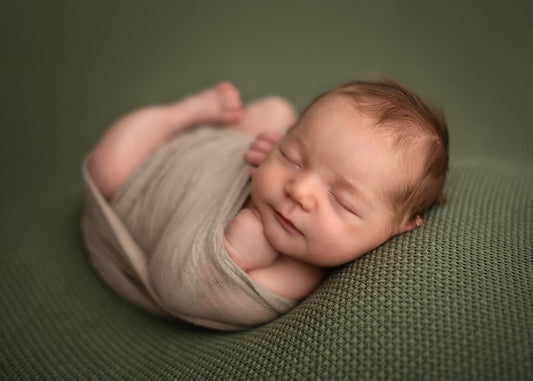 Newborn baby snuggled up in a wrap